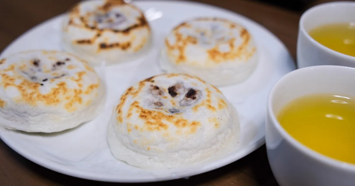 Geröstete Umegae-Mochi-Reiskuchen mit zwei Tassen grünem Tee